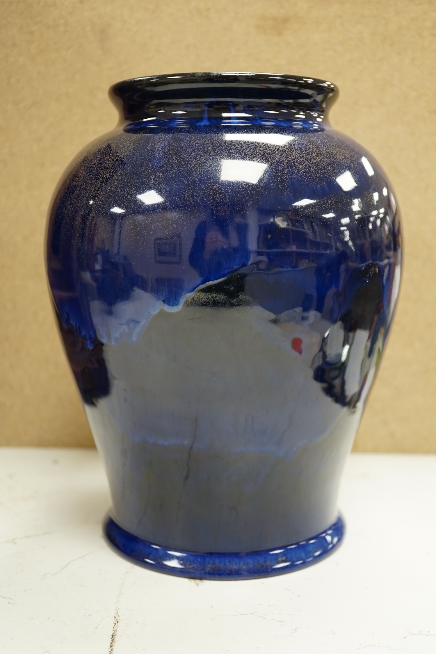 An experimental Doulton Lambeth blue glazed with gilt spray vase, 24cm. Condition - good